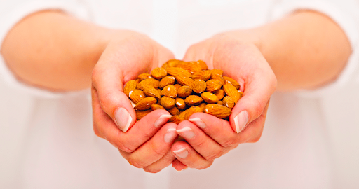 Hands holding almonds