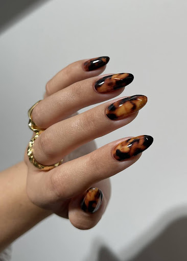 Tortoiseshell nail art featuring black and brown nail foil